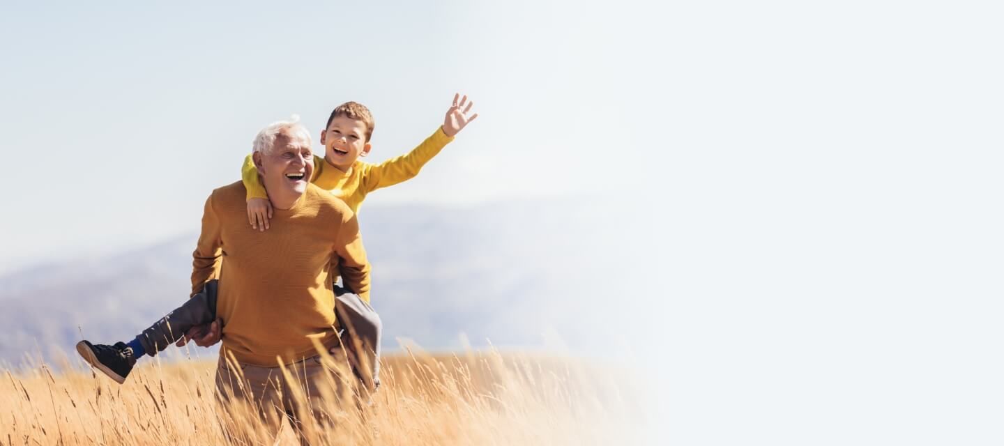 grandfather and child playing outdoors together