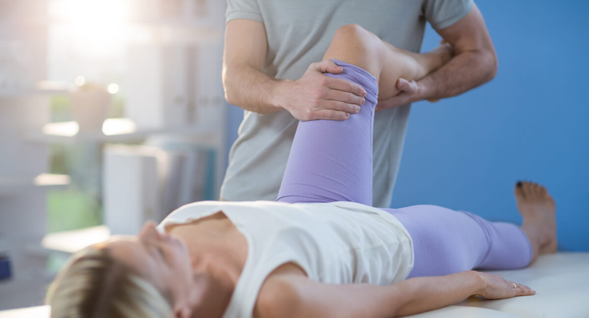 Female patient receiving physical therapy treatment on her leg