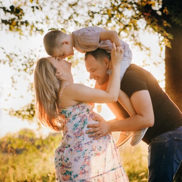 Pregnant mom, dad and young child