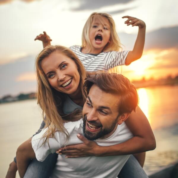 Smiling family of three