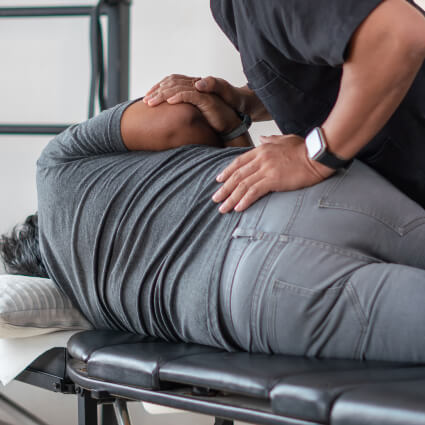 Male patient receiving a chiropractic back adjustment