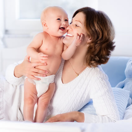 Mom and baby on bed