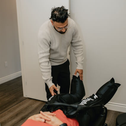 Putting on Normatec compression wraps