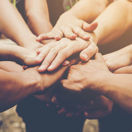 group putting hands into circle