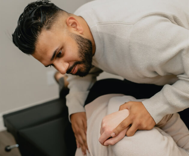 Dr. Bali adjusting patient