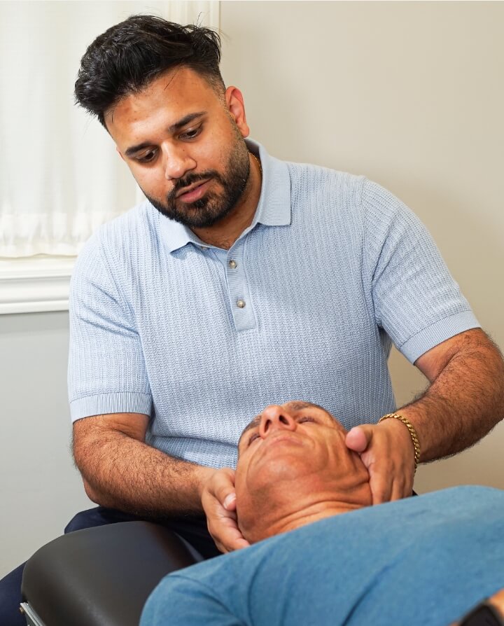 London Chiropractor Dr Bali adjusting patient