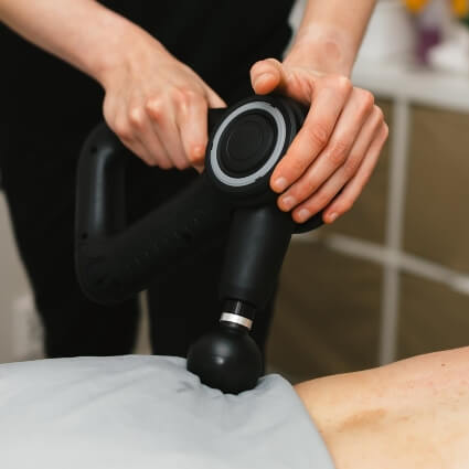 Ian massaging patient with a tool