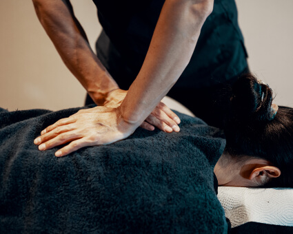 Female patient receiving a chiropractic adjustment