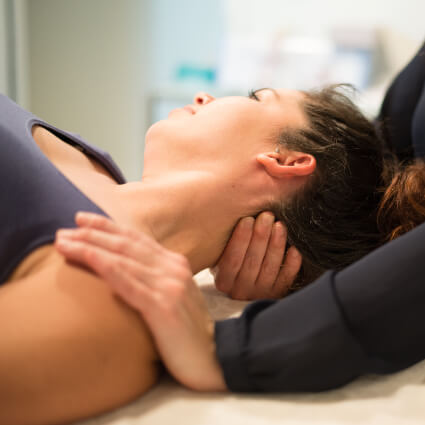 Female patient receiving a neck adjustment
