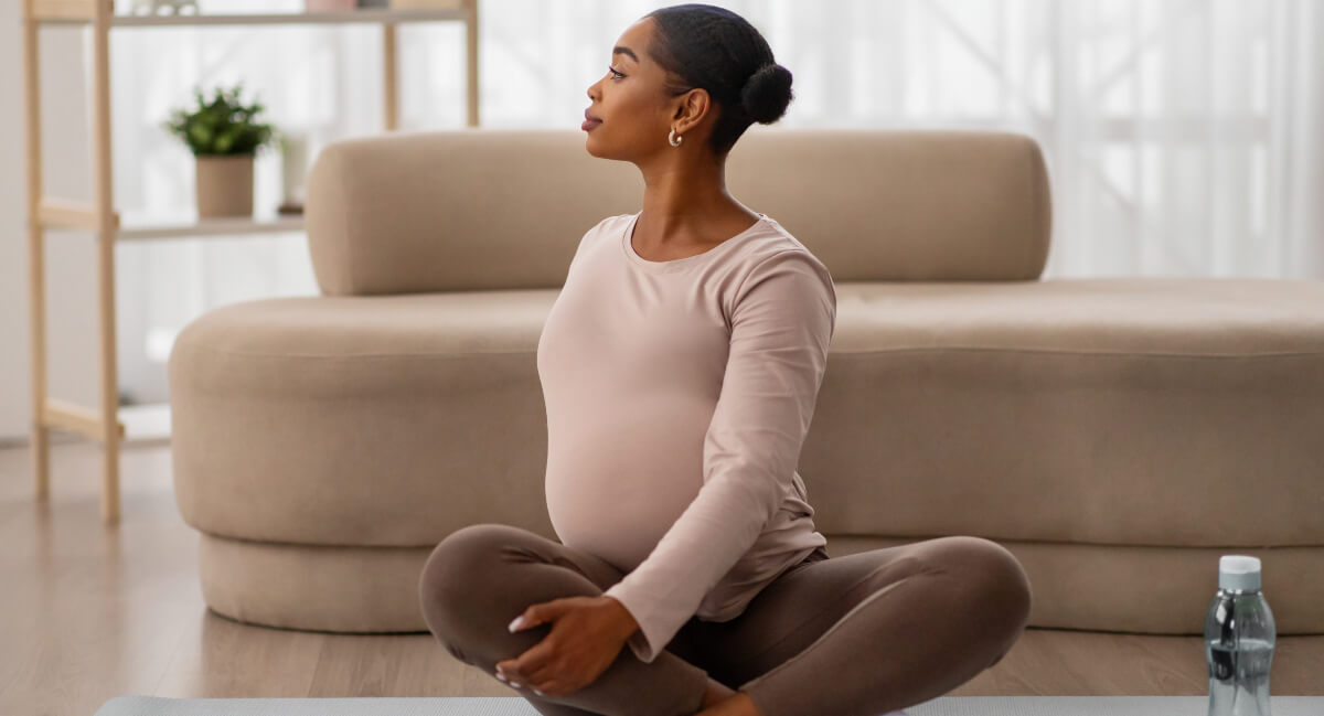 Pregnant woman sitting on carpet