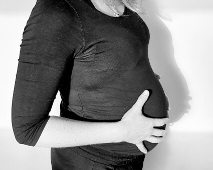 Pregnant woman holding her belly
