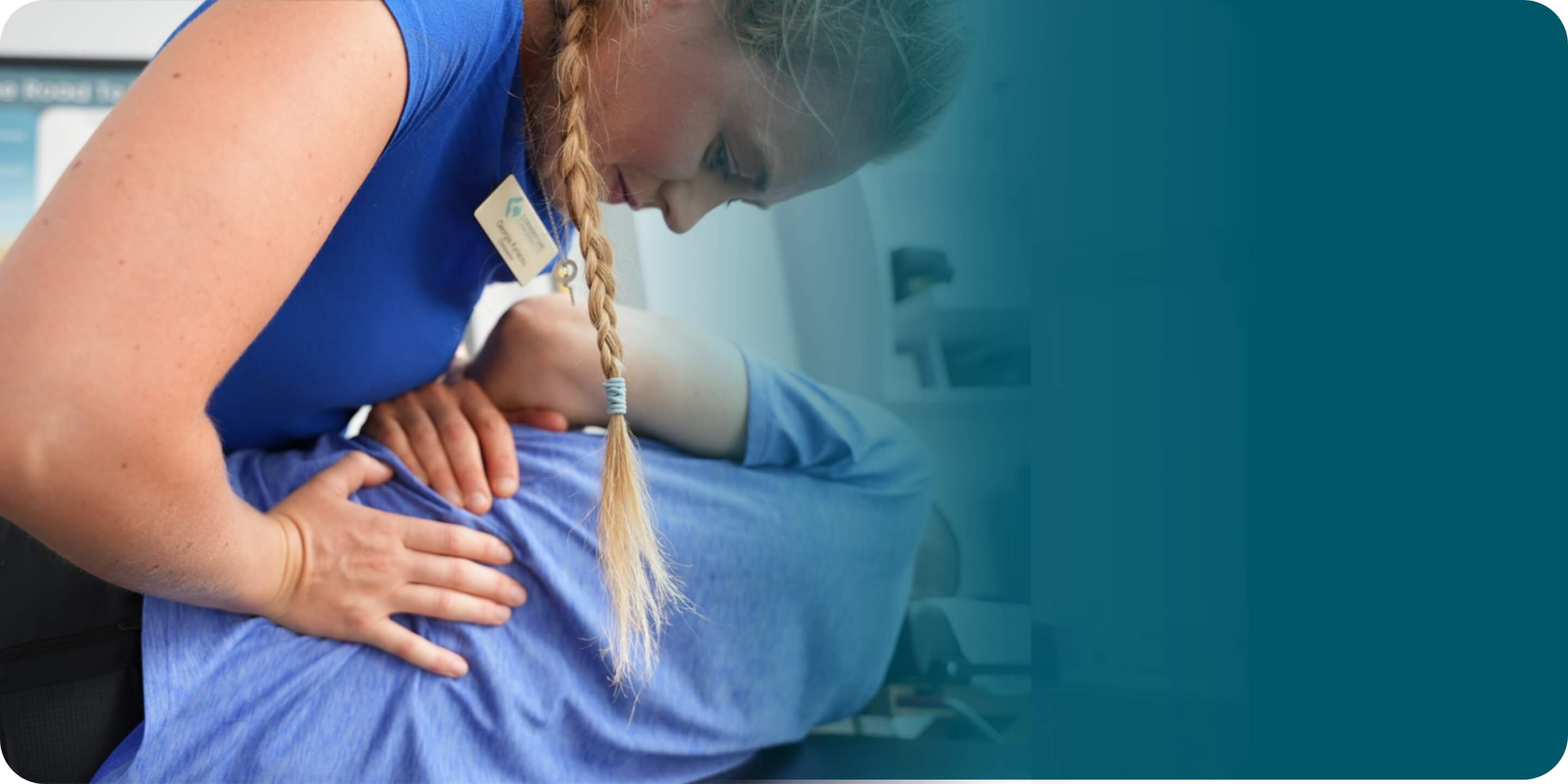 Eastbourne chiropractor Theo Kyriacou adjusting male patient's shoulders
