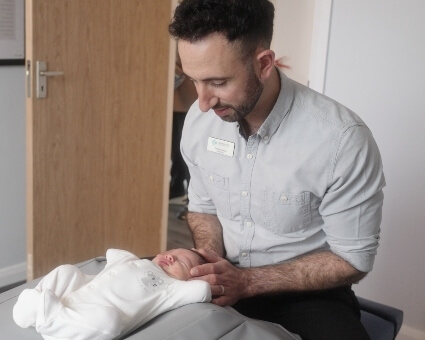 Chiropractor adjusting baby