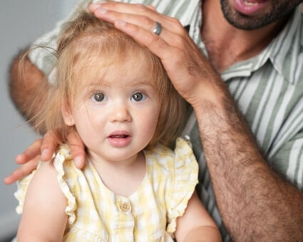 Pediatric patient receiving neck adjustment