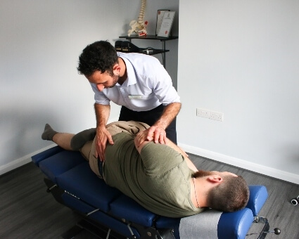 Male patient recieving hip adjustment