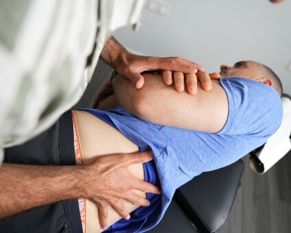 lower-back adjustment blue shirt patient