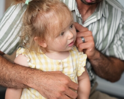 Chiropractor adjusting pediatric patient