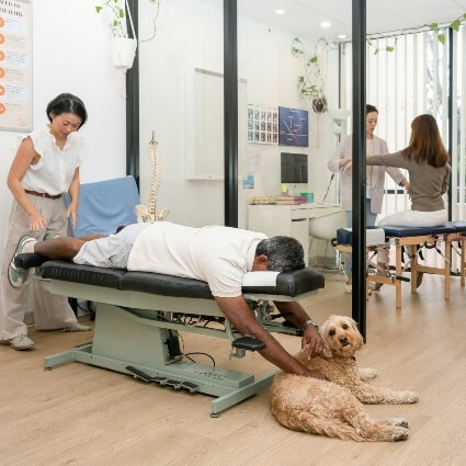 Dr Irene adjusting patient laying on a table