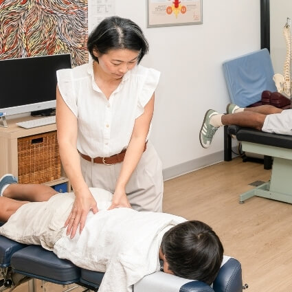 Dr Irene adjusting childs back