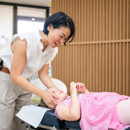 Dr Irene adjusting childs neck
