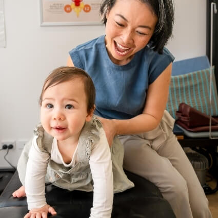 Dr Irene playing with a baby