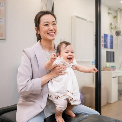 Dr jnae holding a baby on her lap