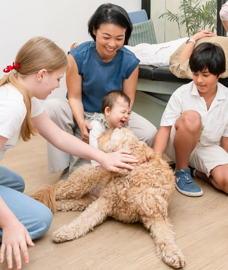 Dr Irene and kids playing with Frankie the dog