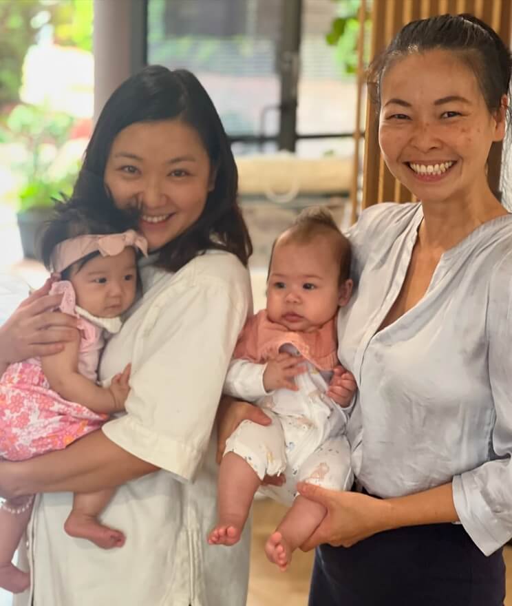 Dr Irene and practice member both holding babies