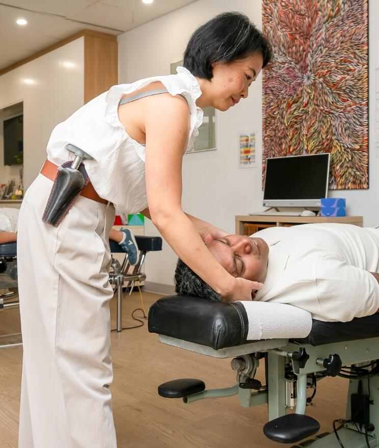 Lindfield chiropractor Dr Irene adjusting practice members neck
