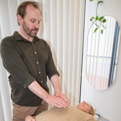 Jeff showing practice member how to meditate