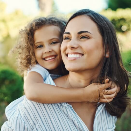 mother and daughter smiling