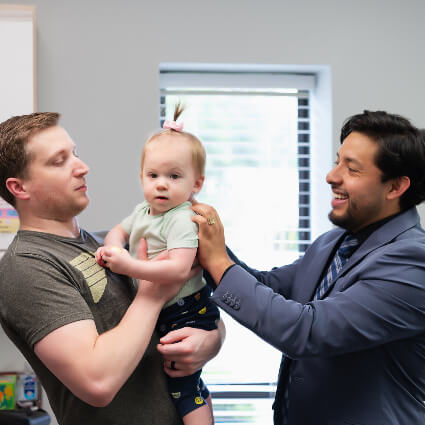 Dr. Garcia adjusting baby