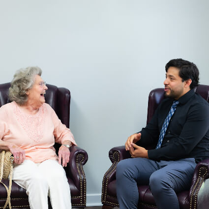 Dr Garcia sitting with patient