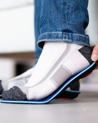 Man fitting orthotics