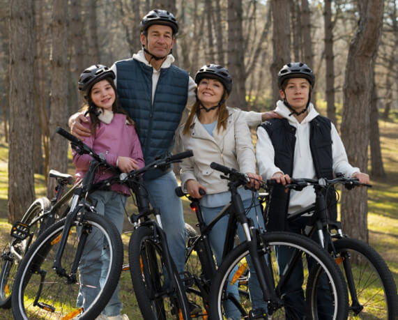 Family of four riding bicycles