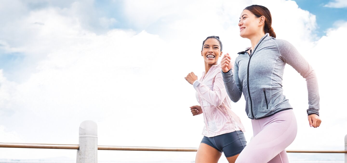 Two smiling women jogging