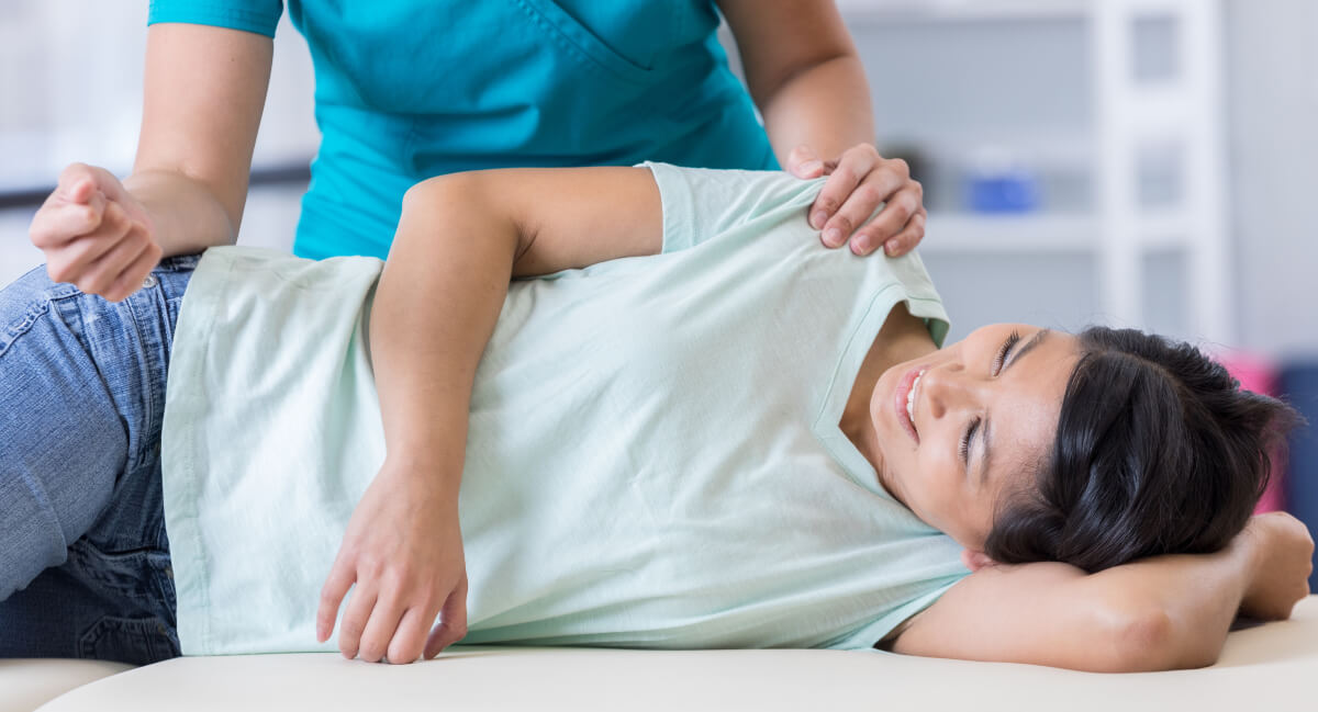 Female patient receiving a chiropractic adjustment