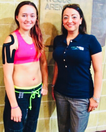 Chiropractor and female athlete posing for a photo