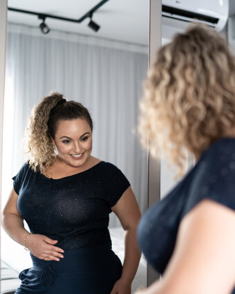 Woman looking at self in mirror