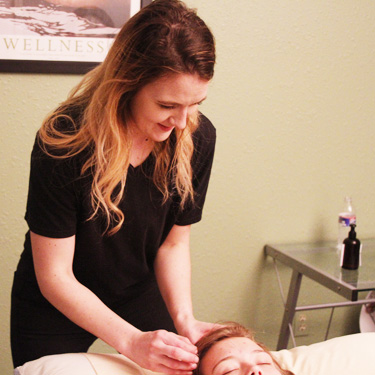 Dr. Amanda doing acupuncture on patient