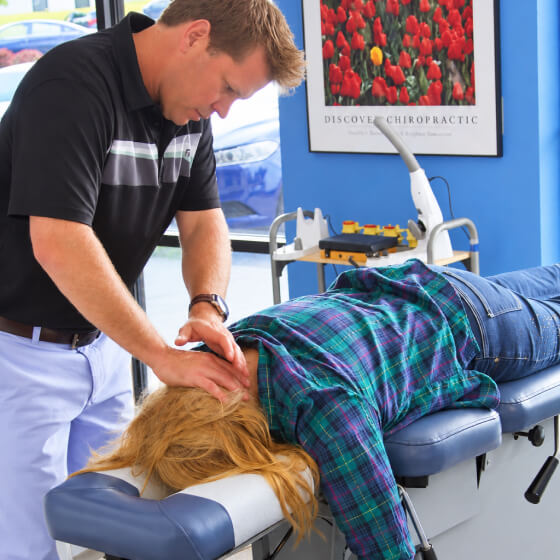 Chiropractor adjusting patient neck