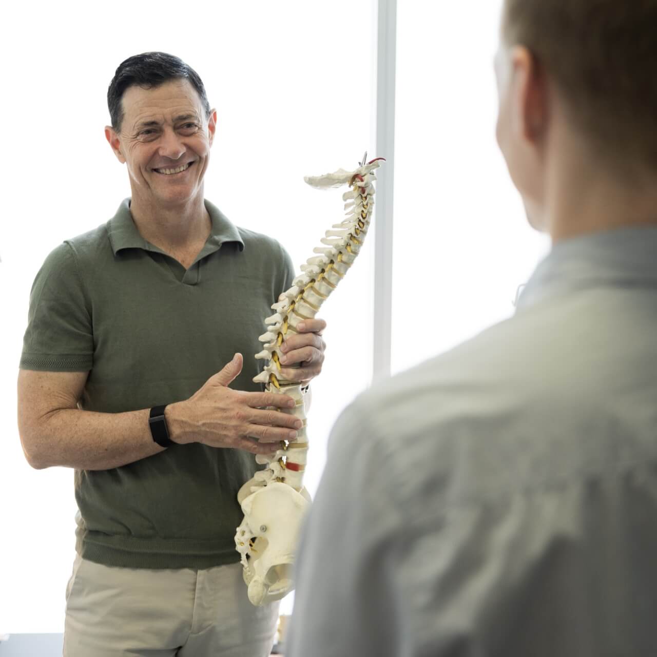 Alexandria Chiropractor Dr Matt holding spine model