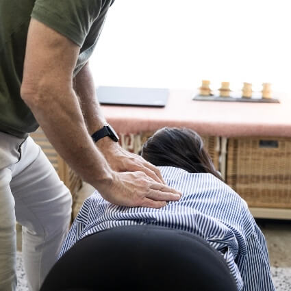 Dr Max adjusting patients back