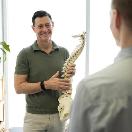 Alexandria chiropractor Dr Max talking with patient