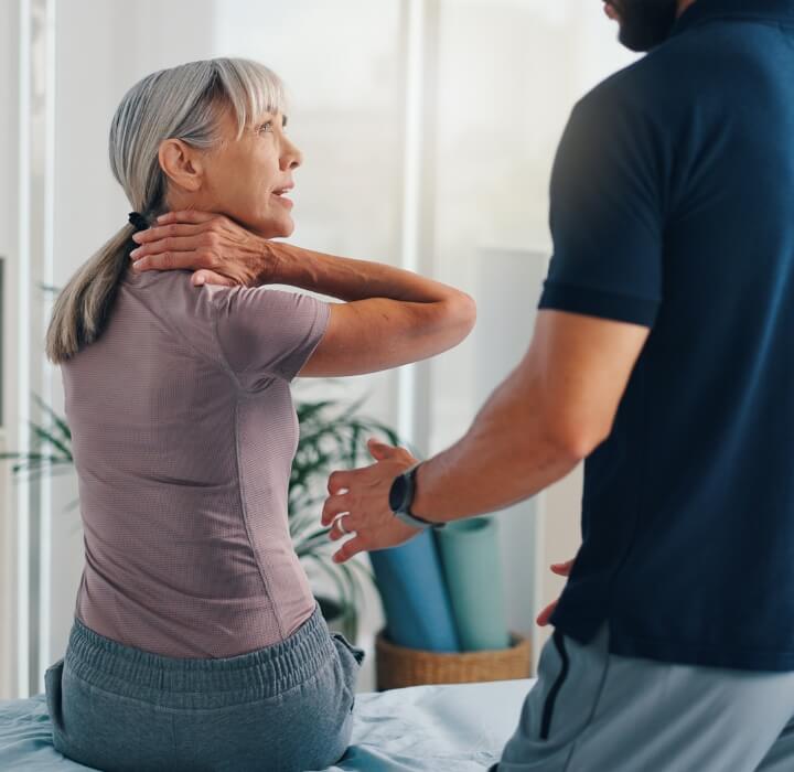 patient holding neck in pain