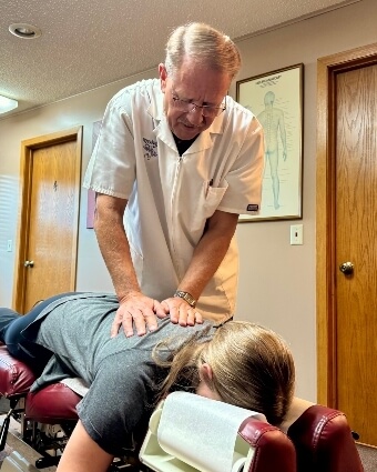 Crookston chiropractor adjusting a female patient