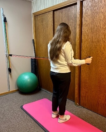 Woman training with resistance bands at Biermaier Chiropractic Clinic