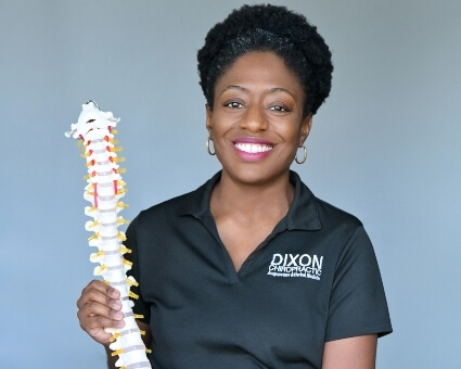 Oakland Park chiropractor Dr. Ashley Dixon holding a spine model
