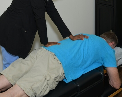 Chiropractic Care Chiropractor adjusting male patient
