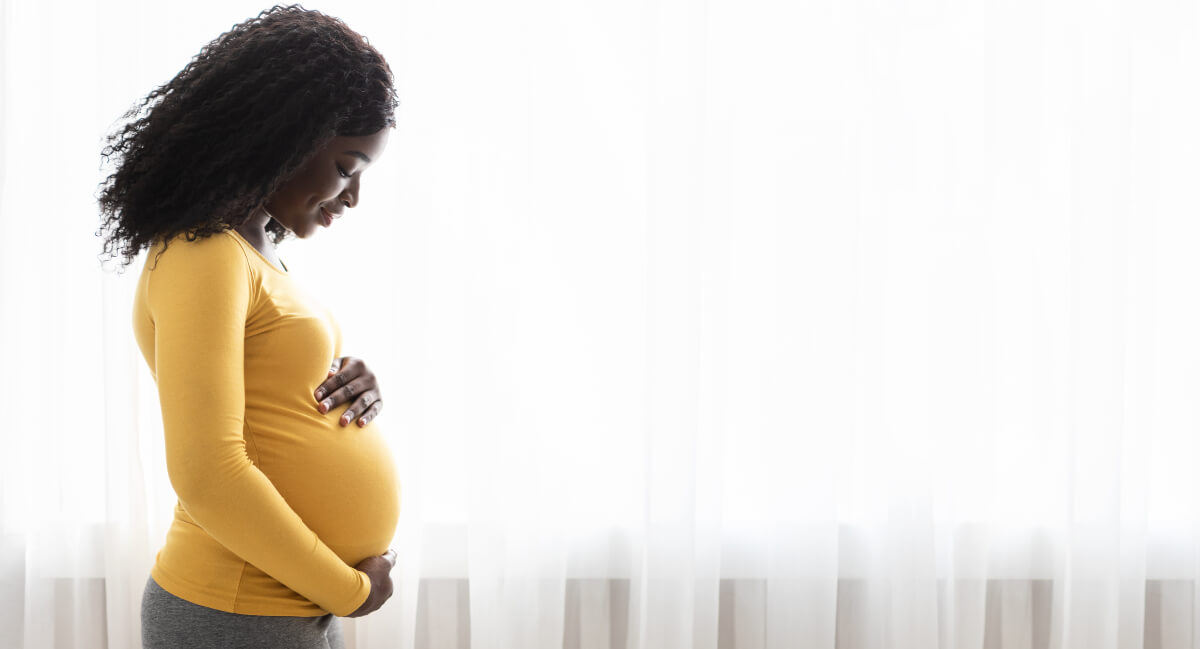 Pregnant lady holding her tummy